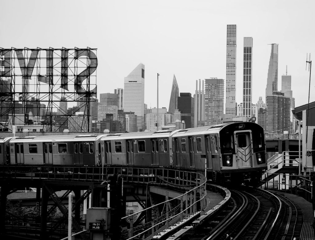 train on tracks in new york in black and white