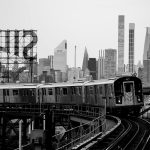 train on tracks in new york in black and white