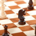 horse chest piece on chess board